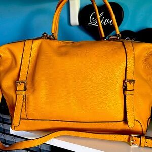 Mustard colored Ora Delphne handbag or shoulder bag.